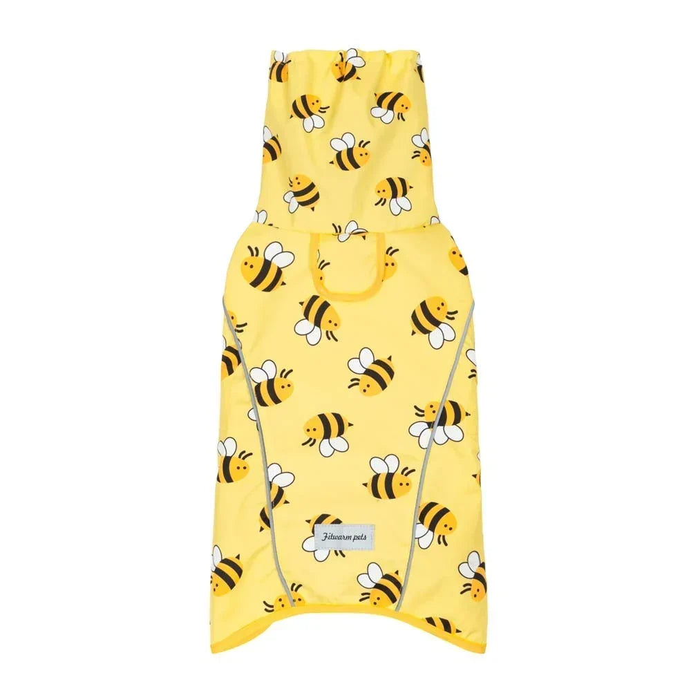 Small dog wearing a yellow bee-print raincoat with a hood and reflective trim