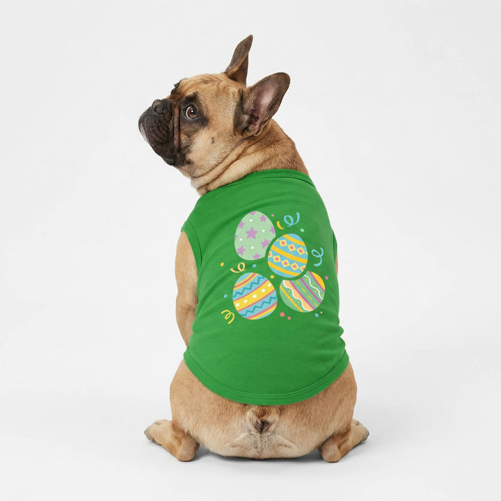 Back view of a French Bulldog wearing a green dog tank top with Easter egg prints