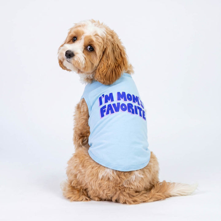 Small dog looks back in a blue dog tank top with 'I'm Mom's Favorite' lettering