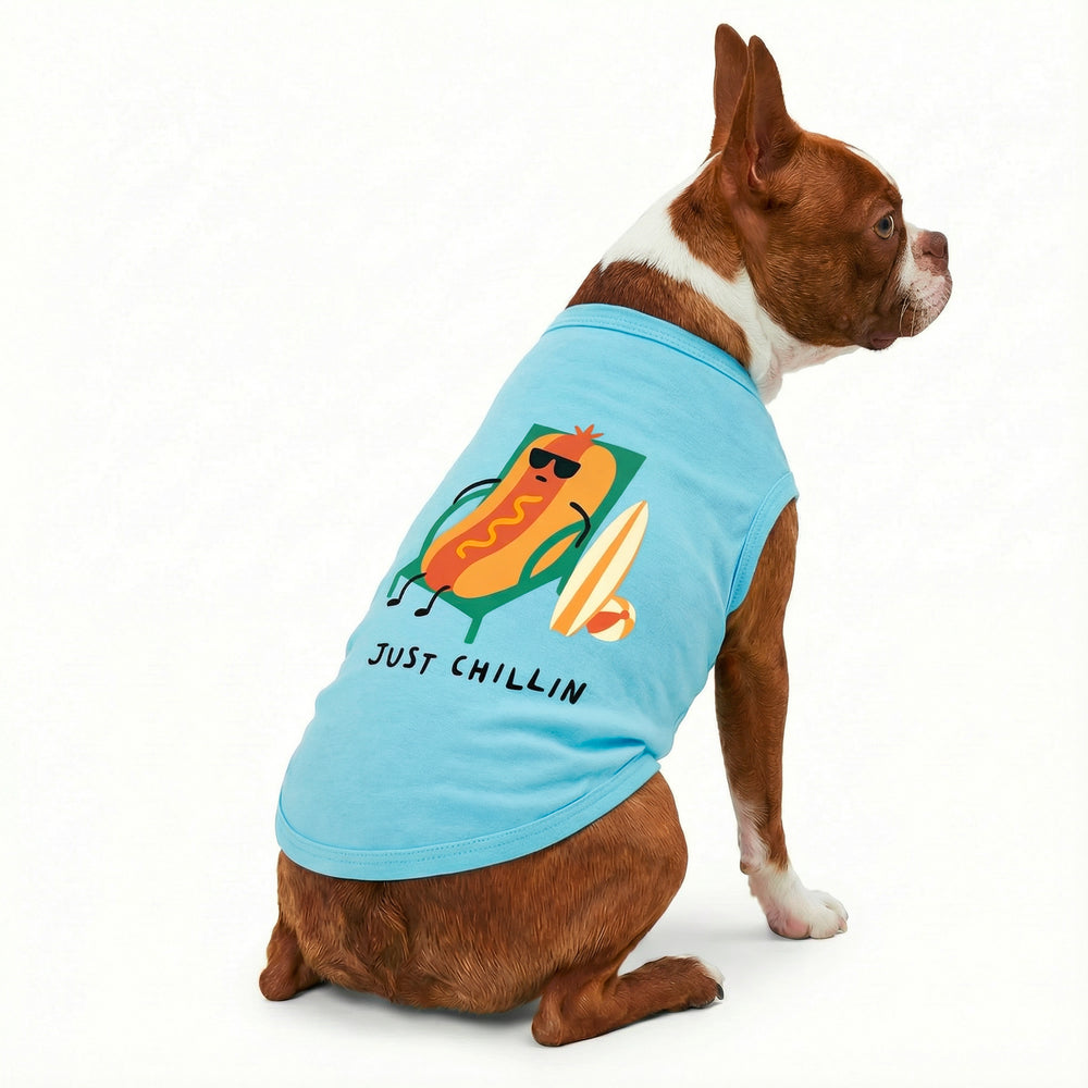 Dog wearing a blue dog tank top with a hot dog graphic and 'Just Chillin' lettering on a white background
