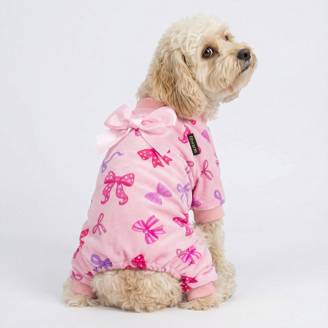 Dog wearing pink dog pajamas with bowknot print and decorative bow