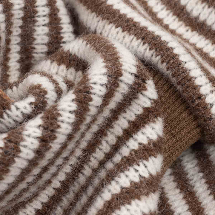 Close-up of a knitted fabric on dog pjs in medium brown and off-white, showing the soft texture and ribbed knit construction