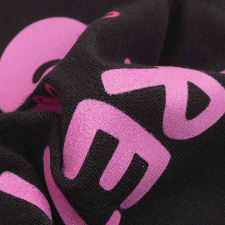 Close up of the fabric on dog winter dress with 'Pretty Girl' lettering