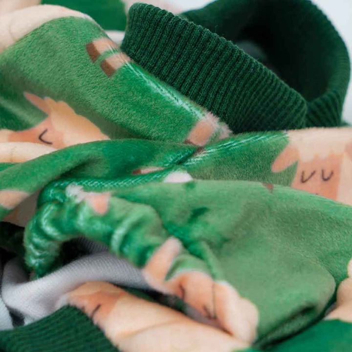 Green dog pajamas with white sheep print, soft fabric, ribbed collar.