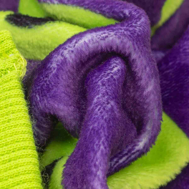 Close-up of plush fleece fabric in bright purple and neon yellow-green, showing the soft texture and folded layers of the material