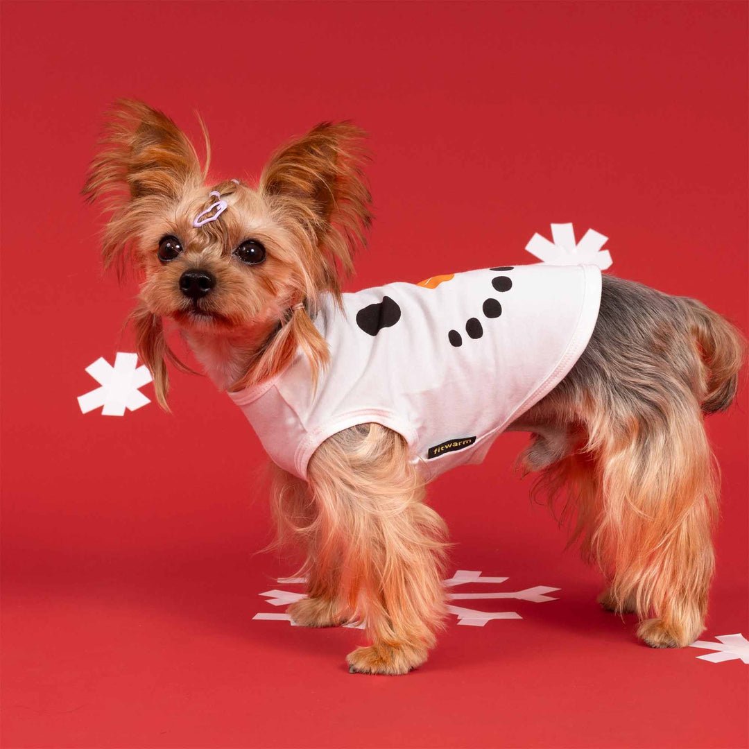Adorable dog dressed in festive white Christmas dog shirt featuring snowman design details