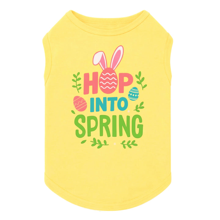 Bright yellow Easter dog shirt featuring “Hop Into Spring” text with bunny ears and colorful egg graphics