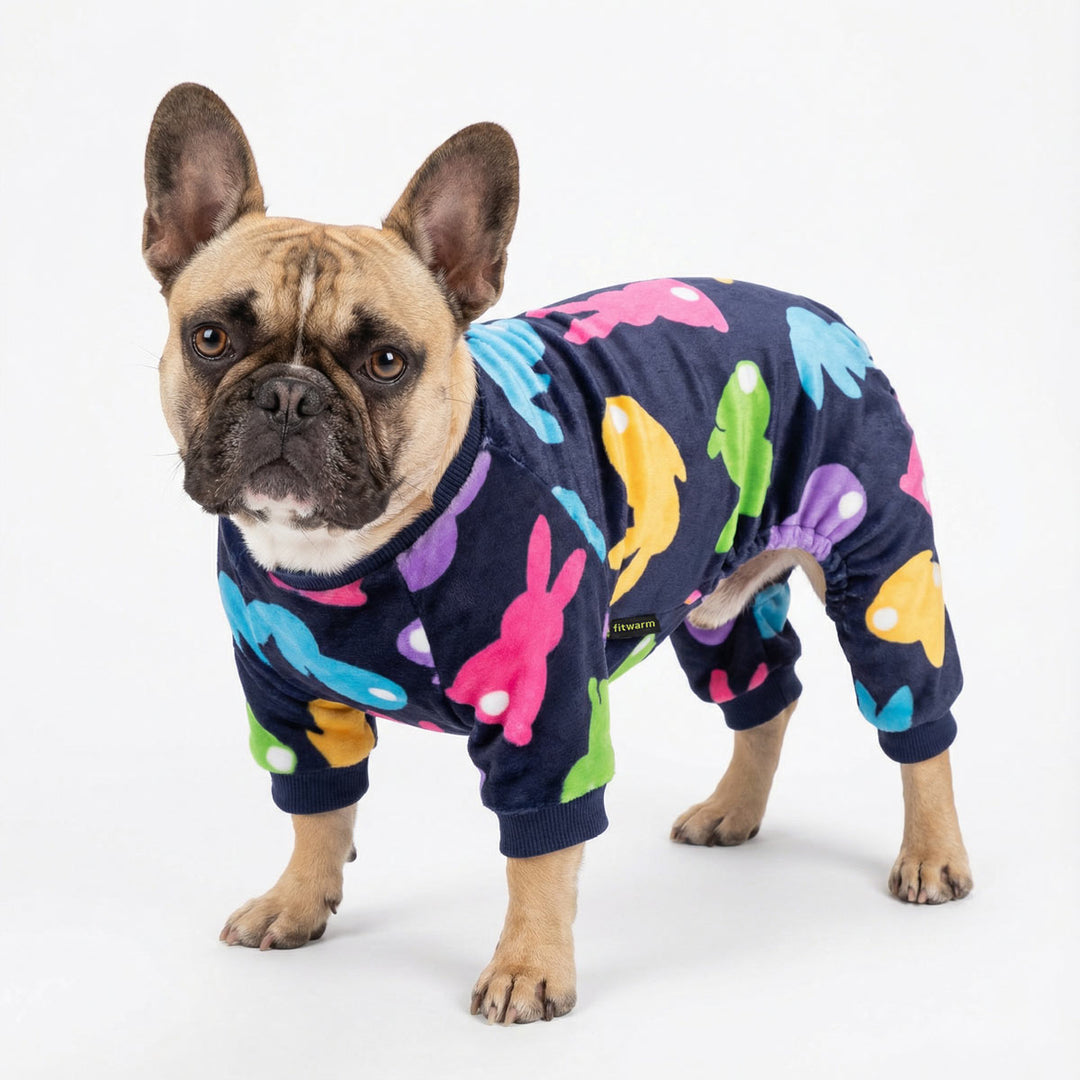 French bulldog wearing colorful dog pajamas with bunny prints, Easter-themed design on a clean white background.