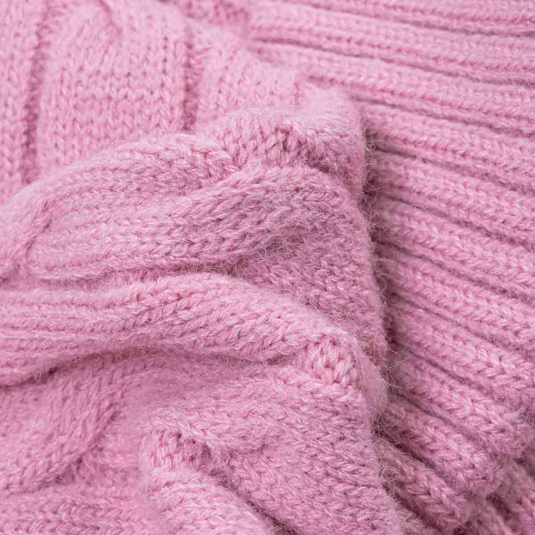 Close-up of cozy chunky knit fabric of dog sweaters