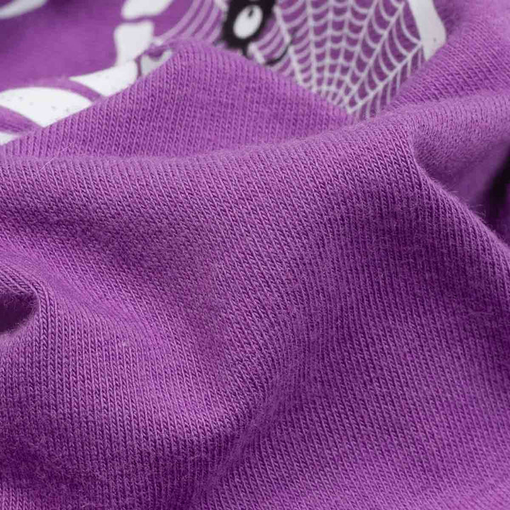 Close-up of a purple ribbed knit fabric with a white spiderweb and spider graphic partially visible in the background