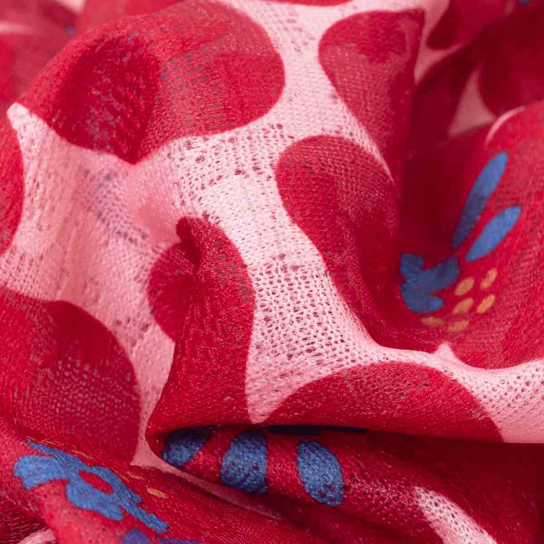 Close-up of red fabric with blue floral patterns