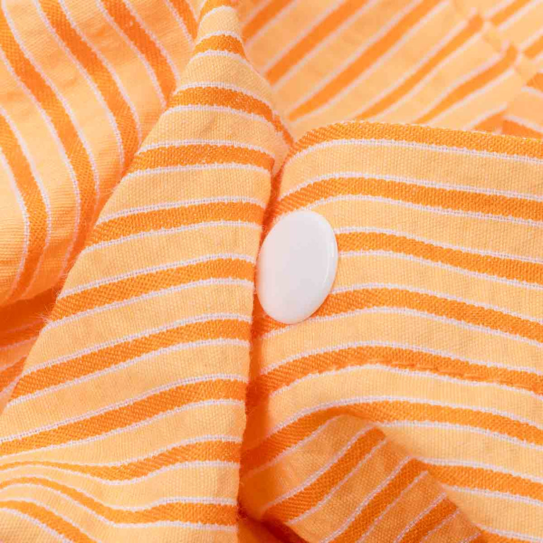 Close-up of orange striped fabric with a button