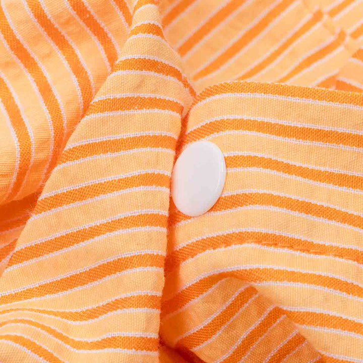 Close-up of orange striped fabric with a button
