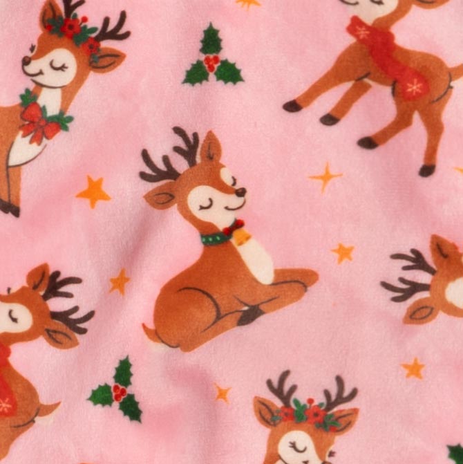 Pattern view of dog pajamas featuring playful reindeer, holly leaves, and yellow stars on pink fabric.