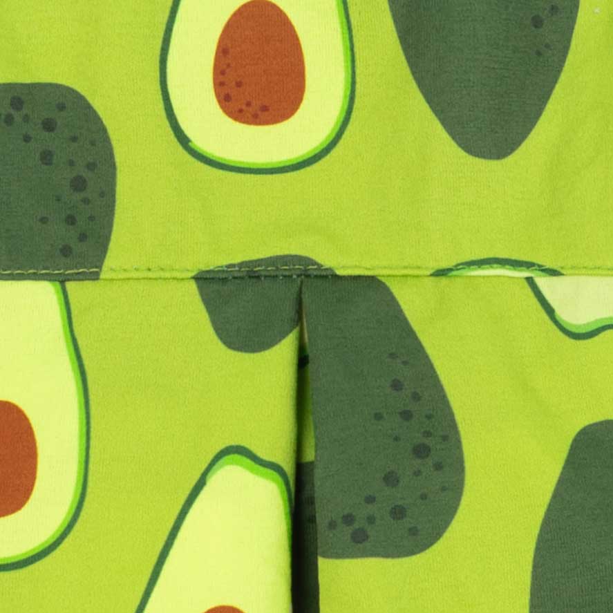 Avocado pattern detail on green dog shirt fabric close-up view