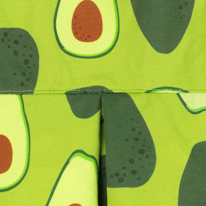 Avocado pattern detail on green dog shirt fabric close-up view