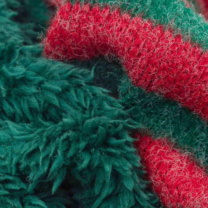 Close-up of a fuzzy, textured knit fabric with alternating thick stripes of dark green and bright red