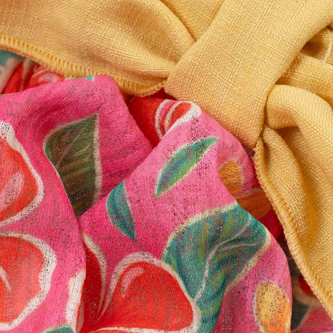 Close-up of pink fabric with floral patterns and yellow fabric