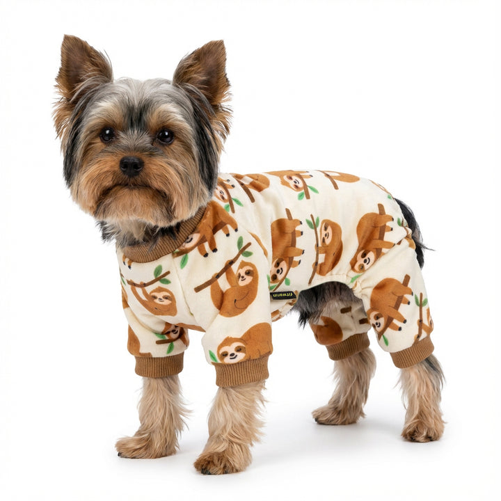 Small dog wearing sloth-themed dog pajamas featuring warm neutral tones and relaxed lounge style