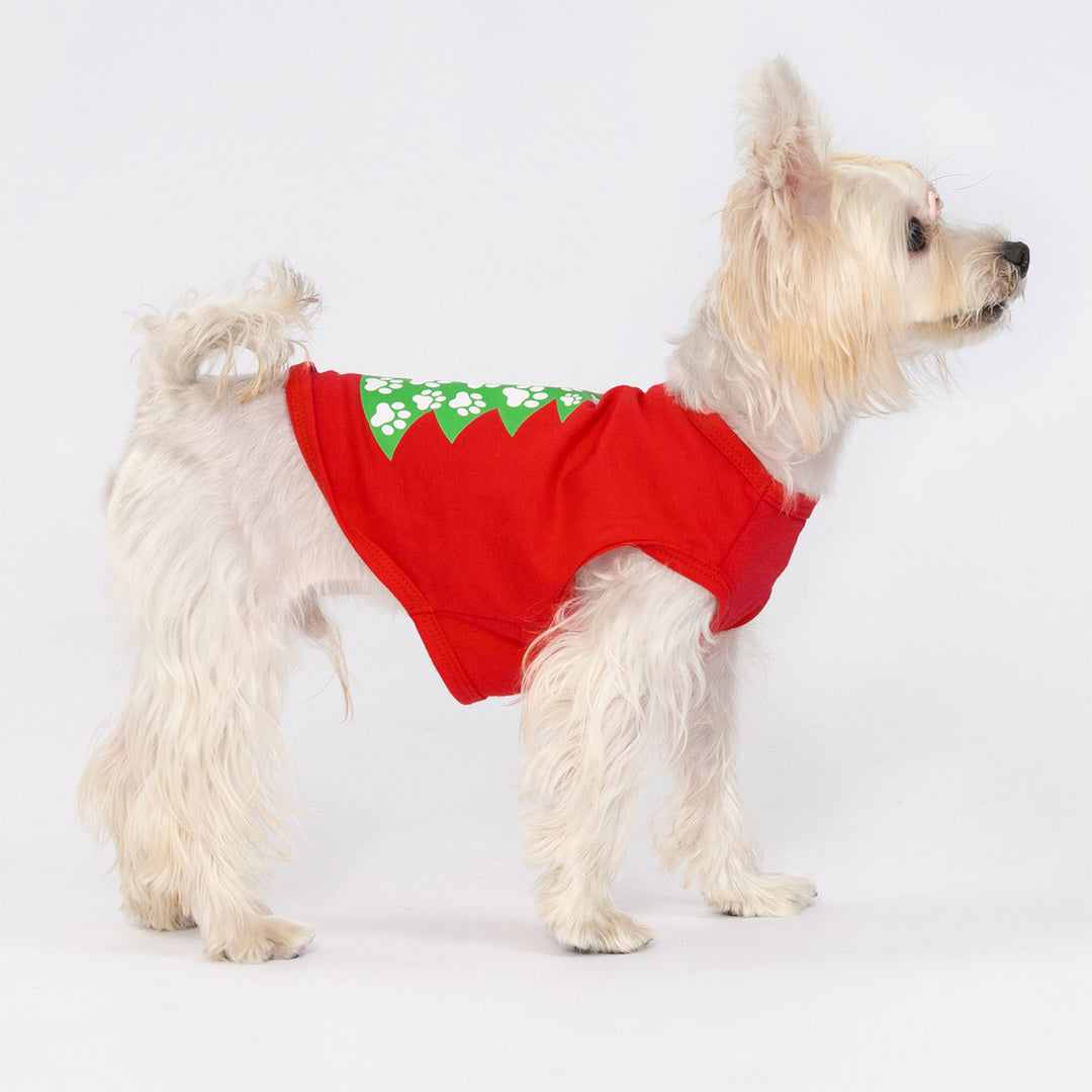Cute dog dressed in red Christmas dog tank top featuring green Christmas tree graphic made of paw prints