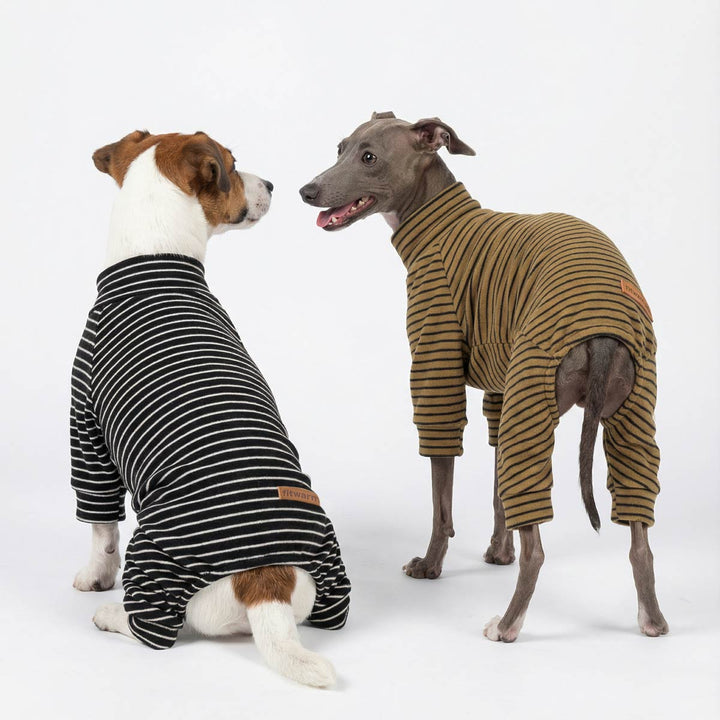 Two stand side by side and watch each other with dog striped onesies