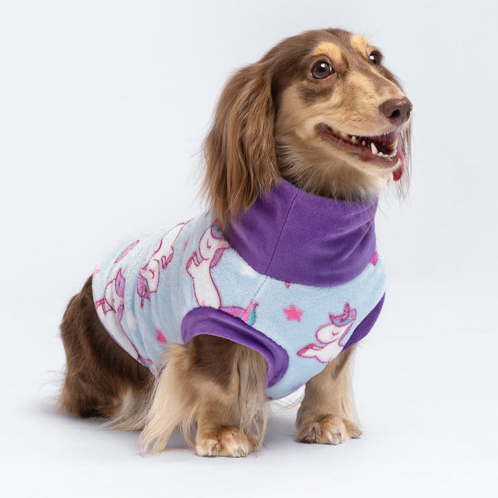 Light blue fleece dog sweater with unicorn print and purple collar on dachshund.