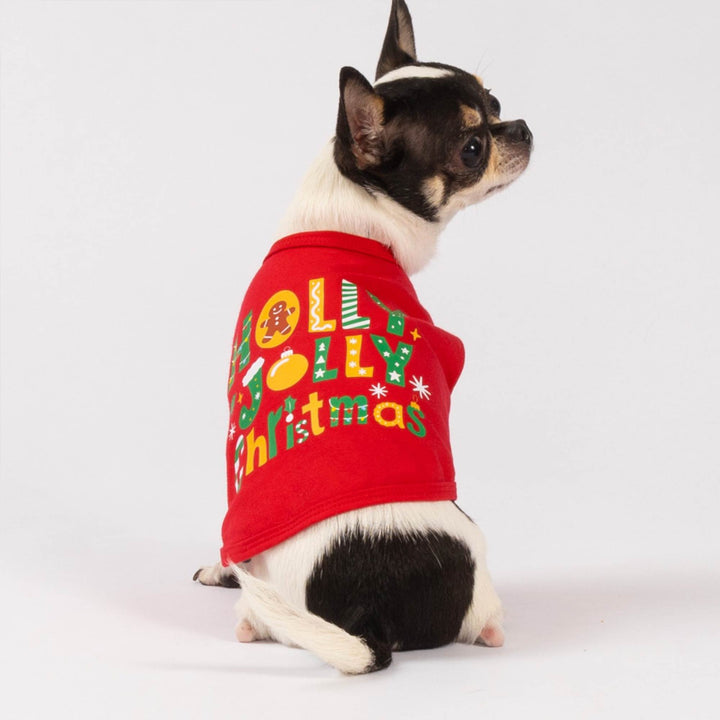 Small dog in a bright red Christmas dog tank top featuring seasonal icons