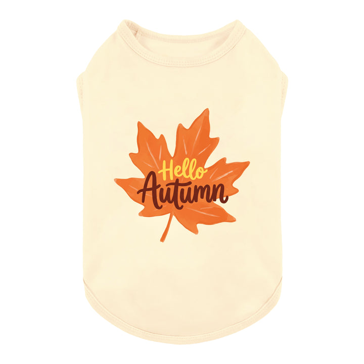 Cream-colored dog tank top featuring a graphic of an orange autumn maple leaf with the words 'Hello Autumn' printed on the front
