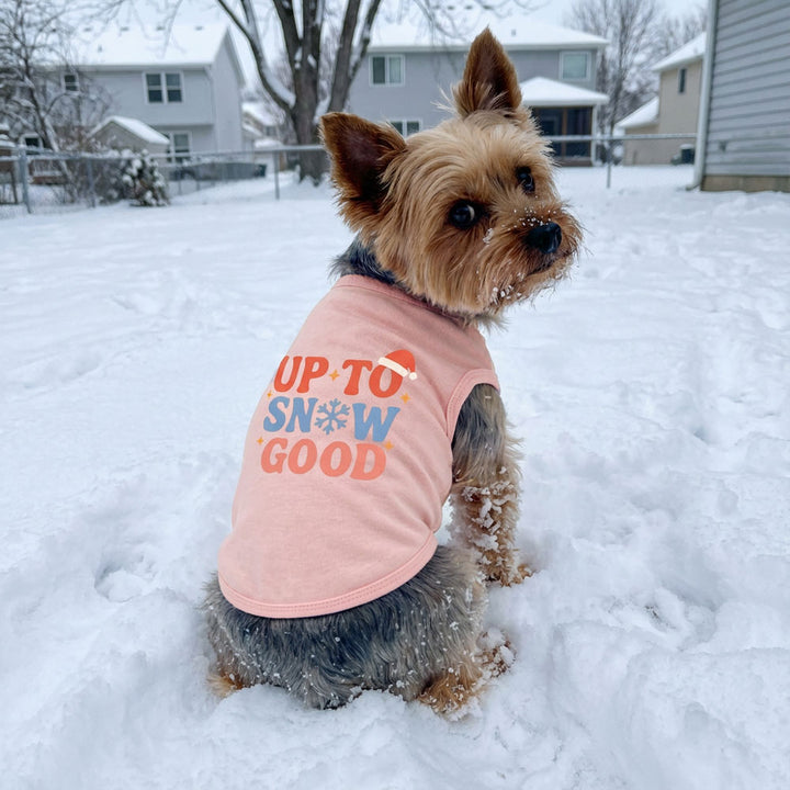 Pink "Up to Snow Good" dog shirt with snowflake and Santa hat, perfect for Christmas.