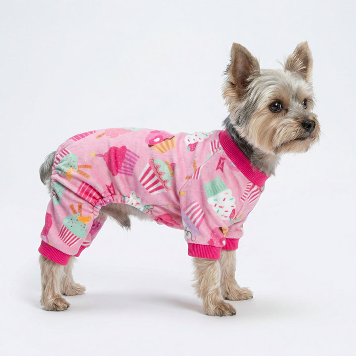Yorkie dressed in cupcake pattern dog pjs with pastel pink tones