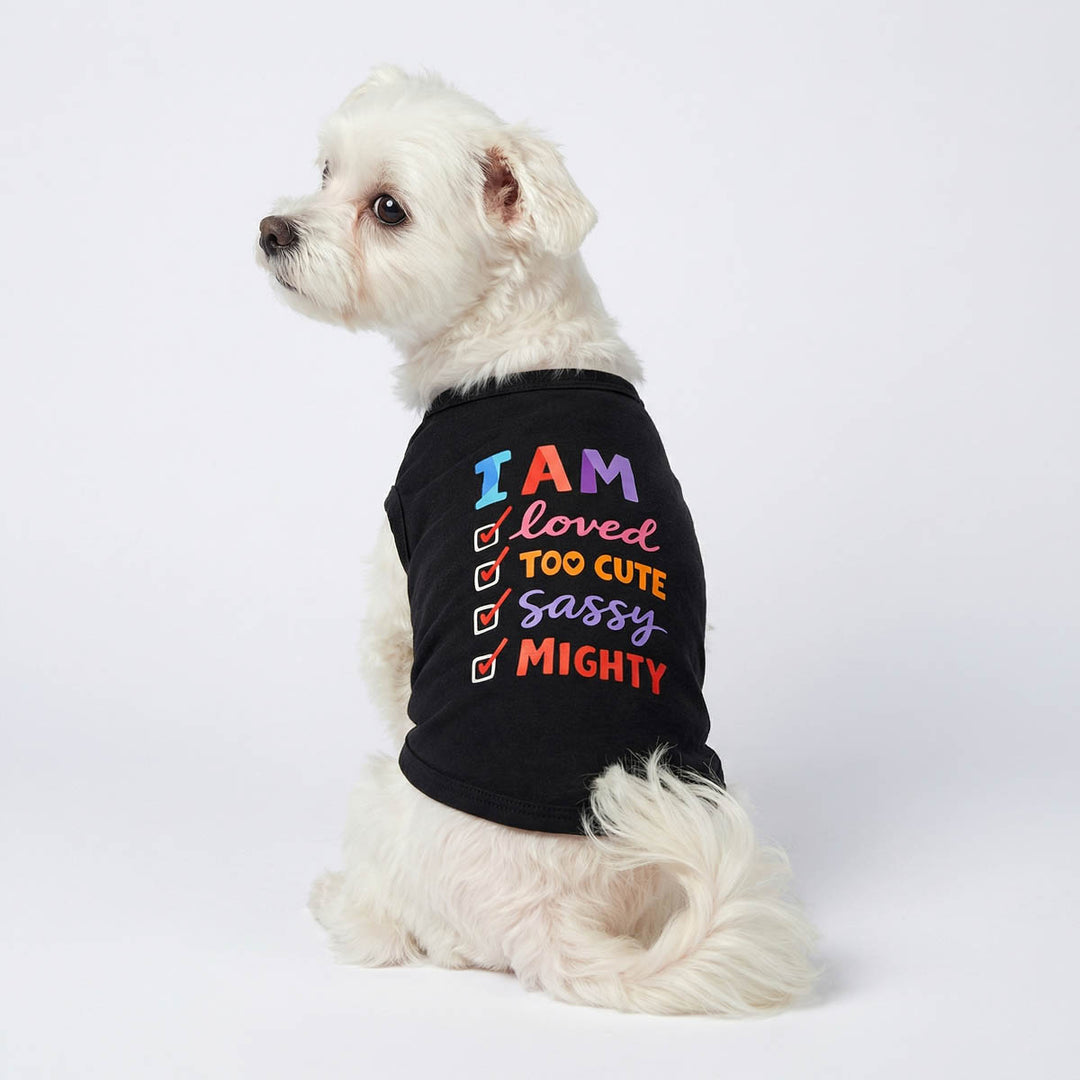 Back view of a small dog wearing a black dog tank top with checklist prints