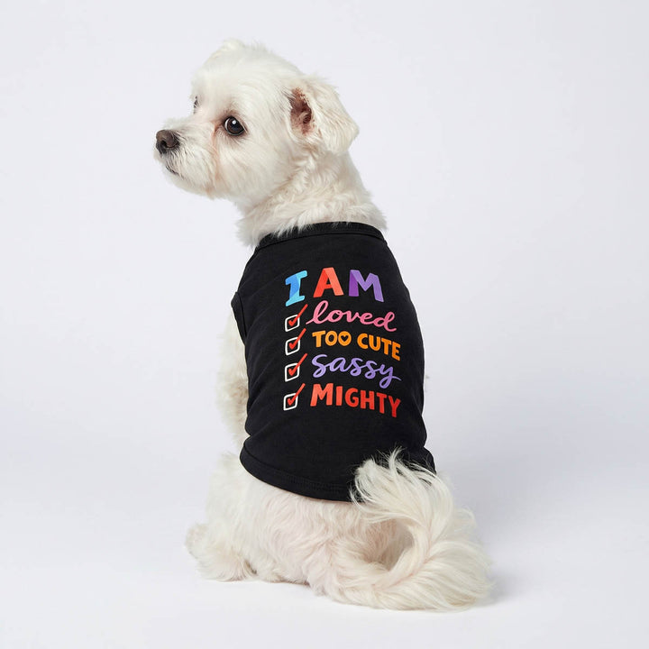Back view of a small dog wearing a black dog tank top with checklist prints