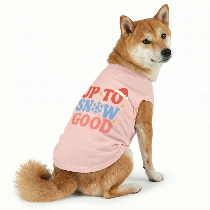 Pink dog shirt with "Up to Snow Good" text, snowflake, and Santa hat. Festive Christmas dog apparel.