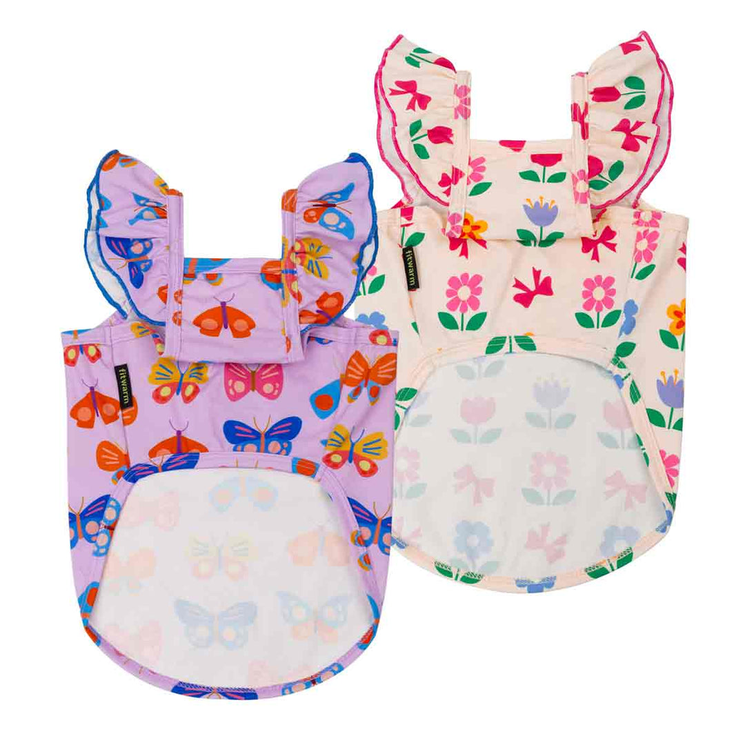 Two ruffle shirts for dogs with butterfly and floral patterns on a white background
