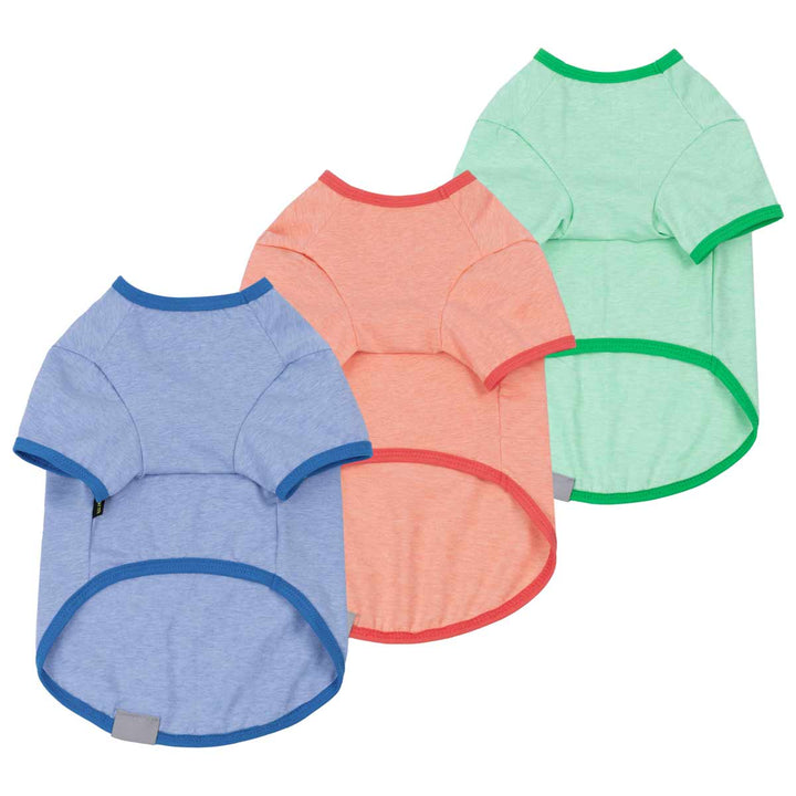 Back view of three dog shirts in blue, peach, and green, featuring contrasting necklines and sleeves.