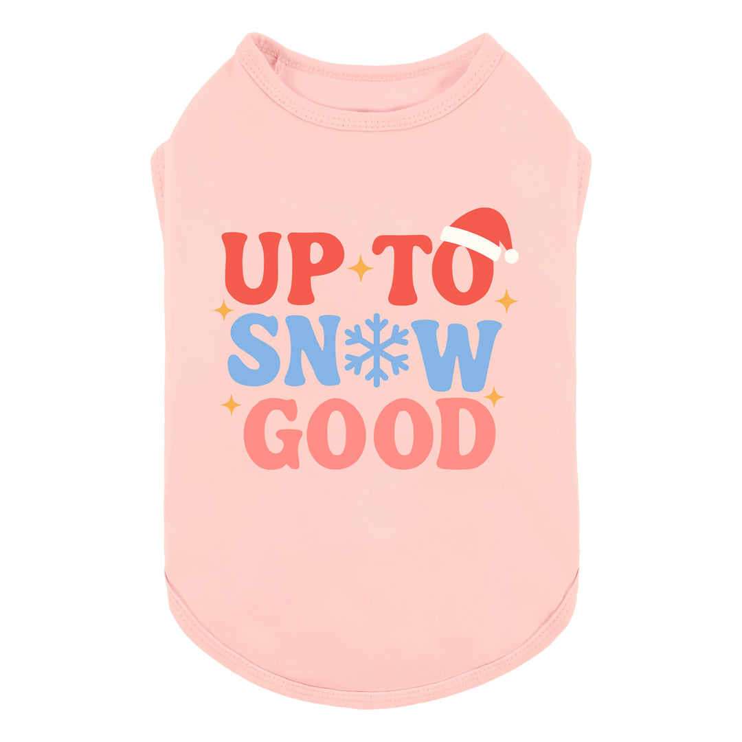 Pink dog shirt with Christmas-themed “Up to Snow Good” lettering and Santa hat detail.