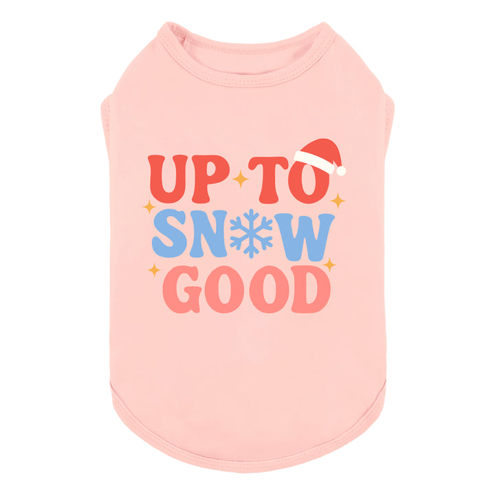 Pink dog shirt with Christmas-themed “Up to Snow Good” lettering and Santa hat detail.