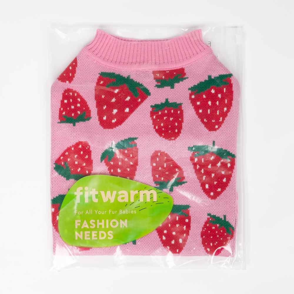 Packaged pink dog sweater with red strawberries, folded neatly inside clear bag.