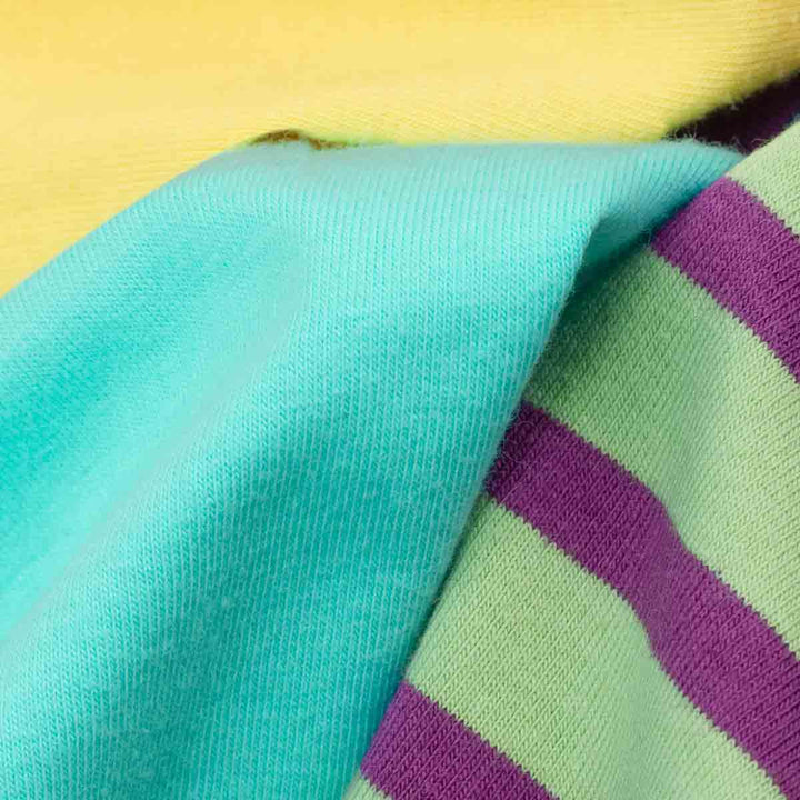 Close-up of colorful fabric with turquoise, green, and purple stripes