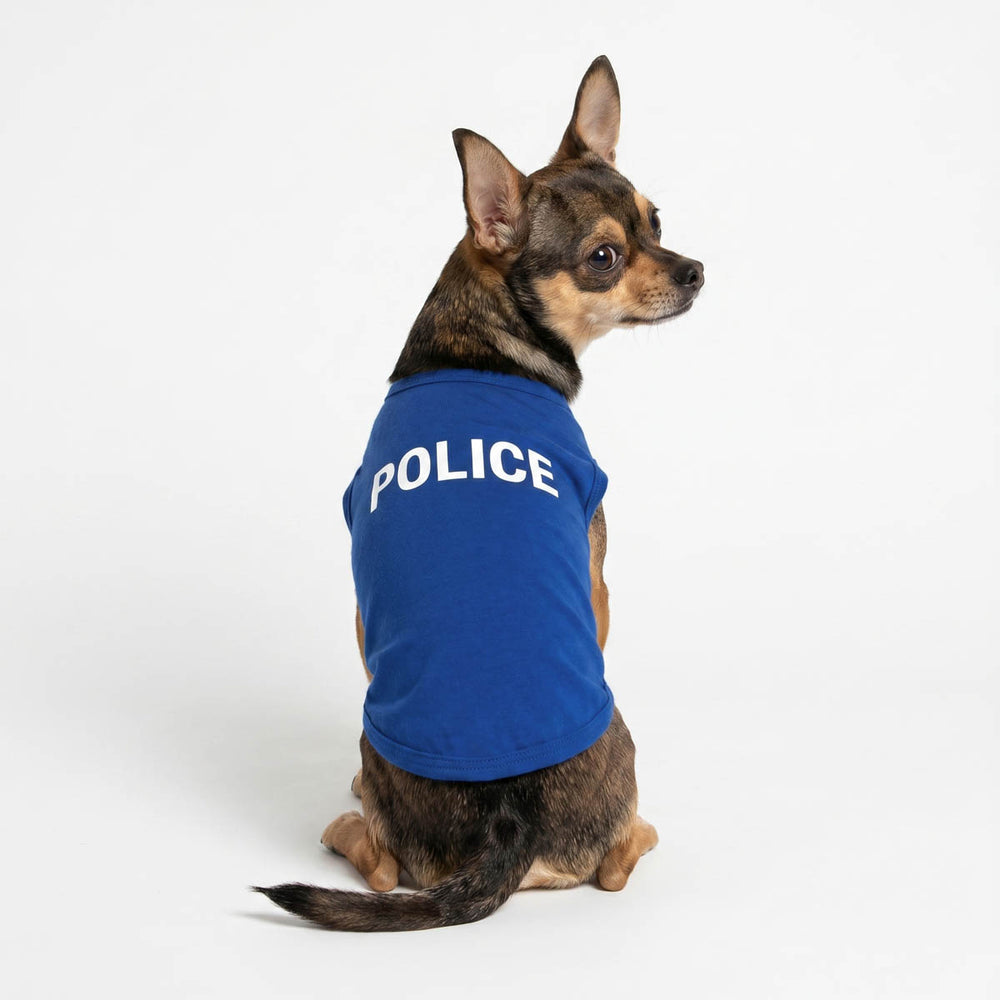 Chihuahua wearing a royal blue dog shirt with the word 'POLICE' printed in white on the back, photographed against a clean white studio background