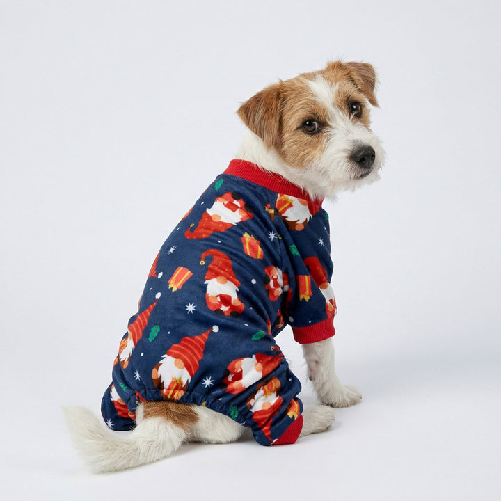 Rear view of dog in soft dog onesie decorated with Christmas themed prints