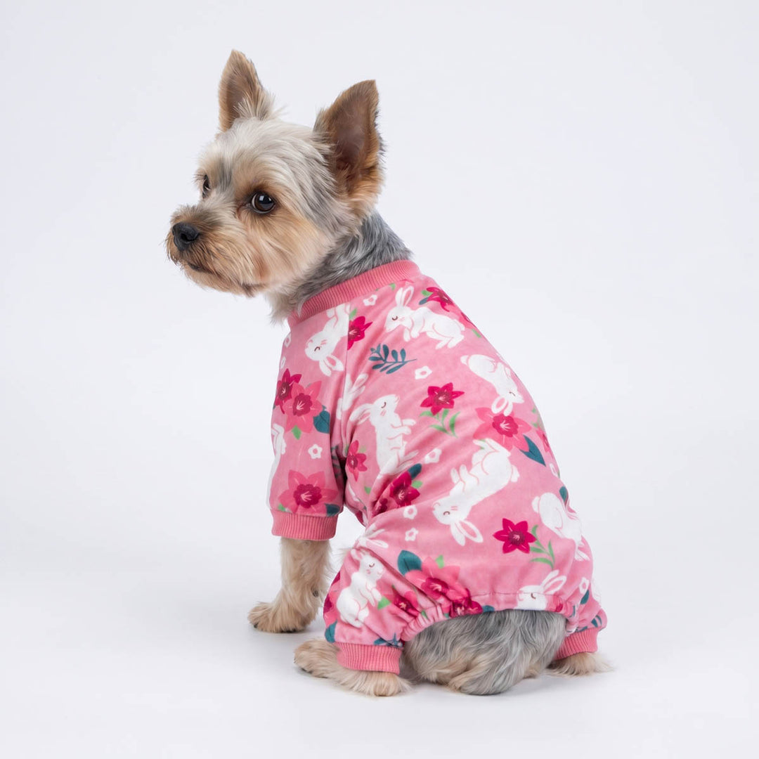 Back view of Yorkie wearing a pink dog pjs with a flower and rabbit pirnts
