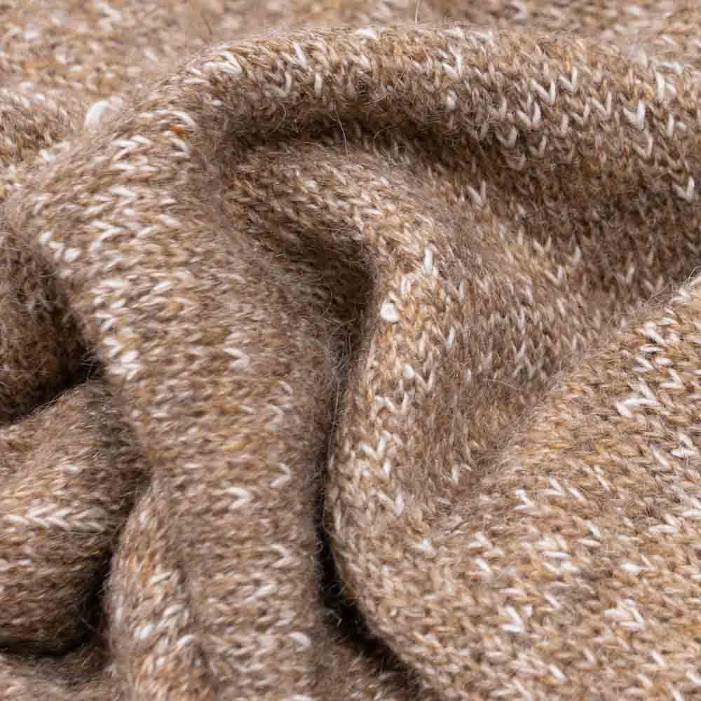 Close-up of heathered knit dog hoodie fabric in speckled light brown, showing soft wool blend texture.
