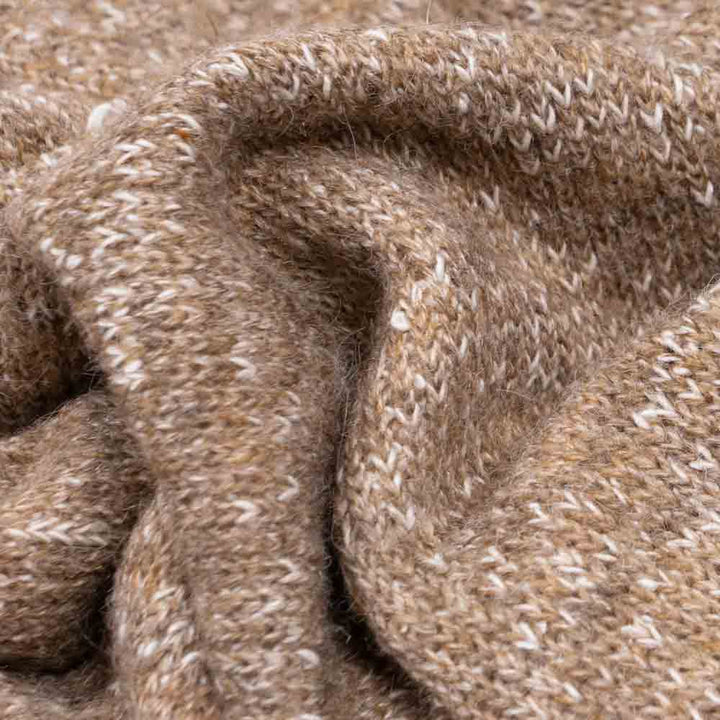 Close-up of heathered knit dog hoodie fabric in speckled light brown, showing soft wool blend texture.