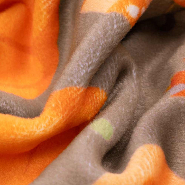 Soft brown and orange fabric detail of Pumpkin Print Dog Pajamas, highlighting cozy polyester blend.