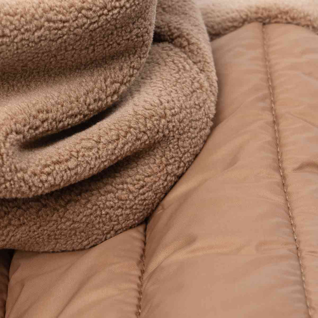 Close-up of soft fleece and padded fabric for a brown Dog hoodie, warm and comfy material.