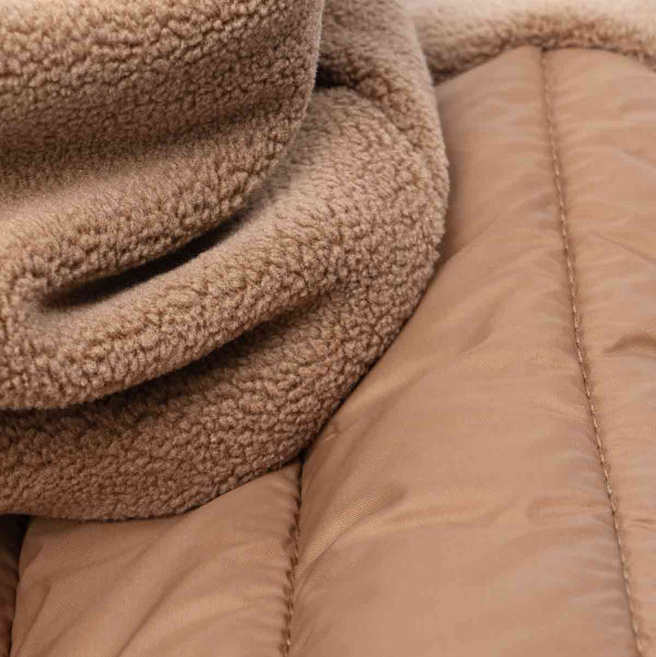 Close-up of soft fleece and padded fabric for a brown Dog hoodie, warm and comfy material.