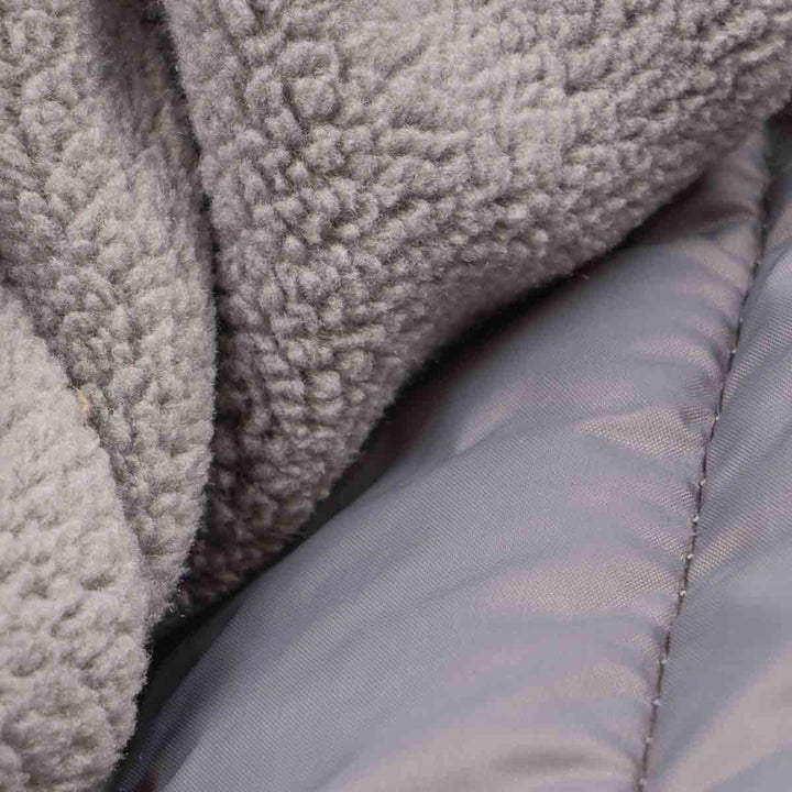 Textured fleece and quilted padding detail of a gray Dog hoodie, breathable and thermal.