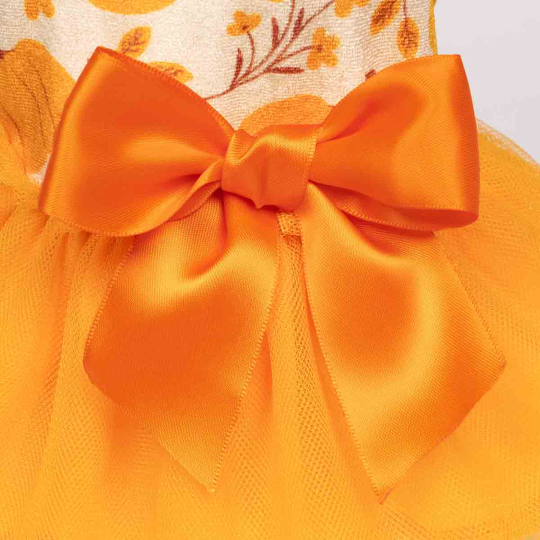 Dog dress with an orange satin bow and soft mesh layers, perfect for fall celebrations.
