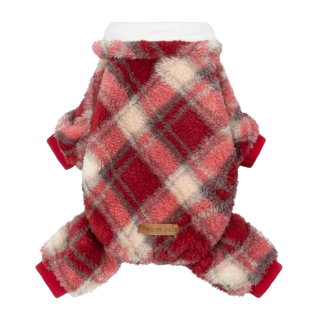 Red plaid dog pajamas on fluffy dog with festive holiday backdrop